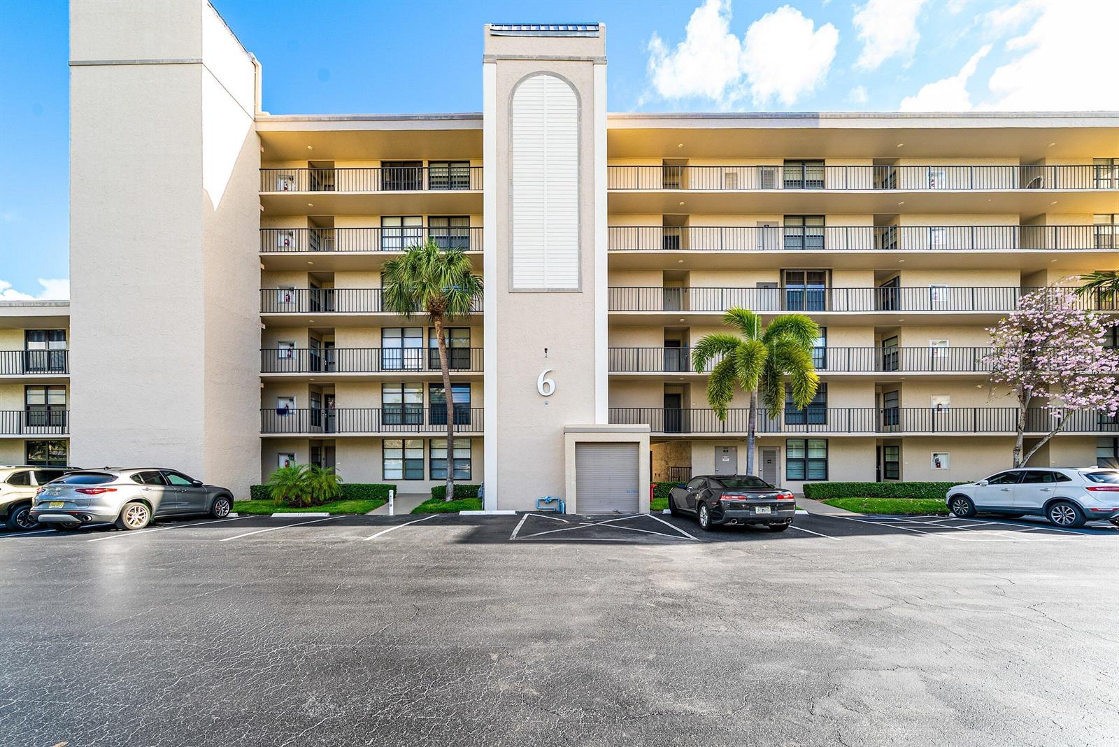 A multi-story apartment building with balconies, palm trees, and a parking lot in front — 6 Royal Palm Way # 605, Boca Raton FL 33432, BOCA RATON, FL