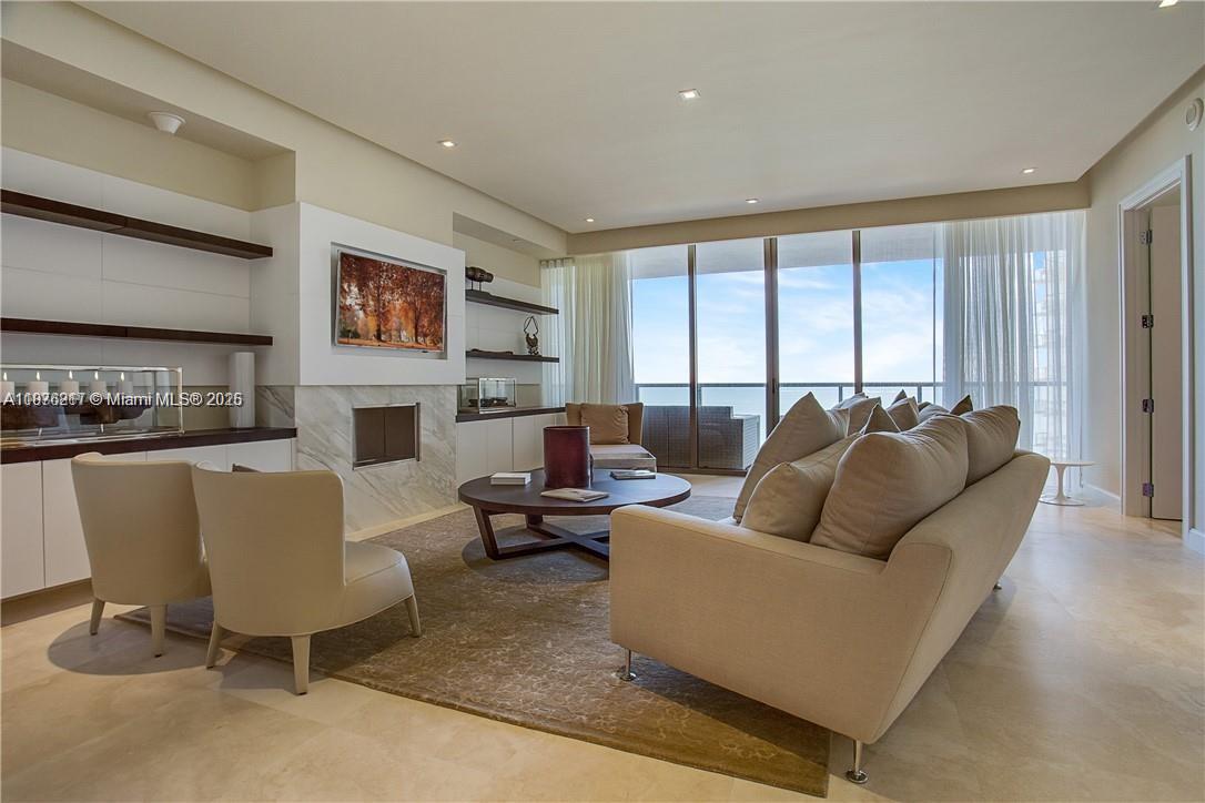 A modern living room features a beige sofa, two armchairs, a coffee table, and floor-to-ceiling windows — 9705 Collins Ave # 903N, Bal Harbour FL 33154, BAL HARBOUR, FL