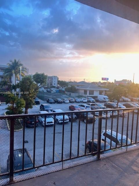 An elevated view of a parking lot at sunset with buildings in the background — 5775 W 20th Ave # 310, Hialeah FL 33012, HIALEAH, FL