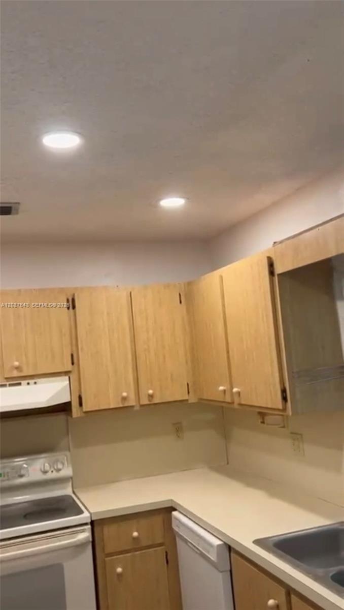 A bedroom features white walls, tiled flooring, a ceiling fan, and a louvered closet door — 792 Lantern Tree Ln # 792, Wellington FL 33414, WELLINGTON, FL