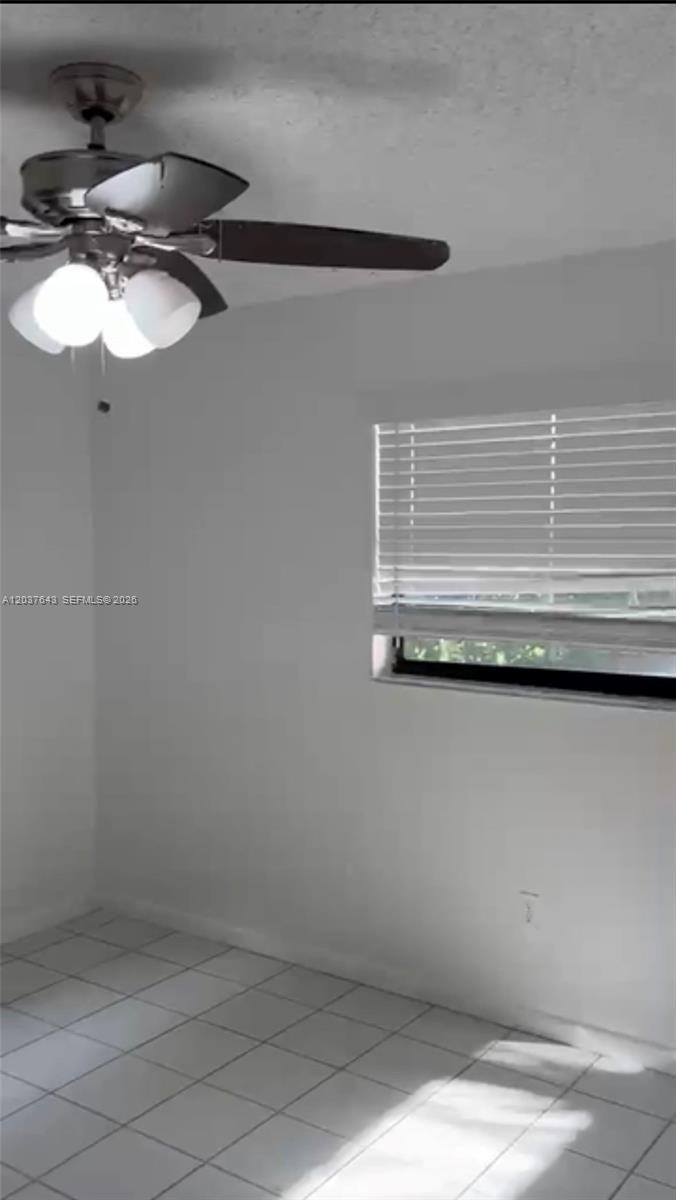 A bathroom features a vanity, a toilet with an over-the-toilet cabinet, and a tiled shower — 792 Lantern Tree Ln # 792, Wellington FL 33414, WELLINGTON, FL