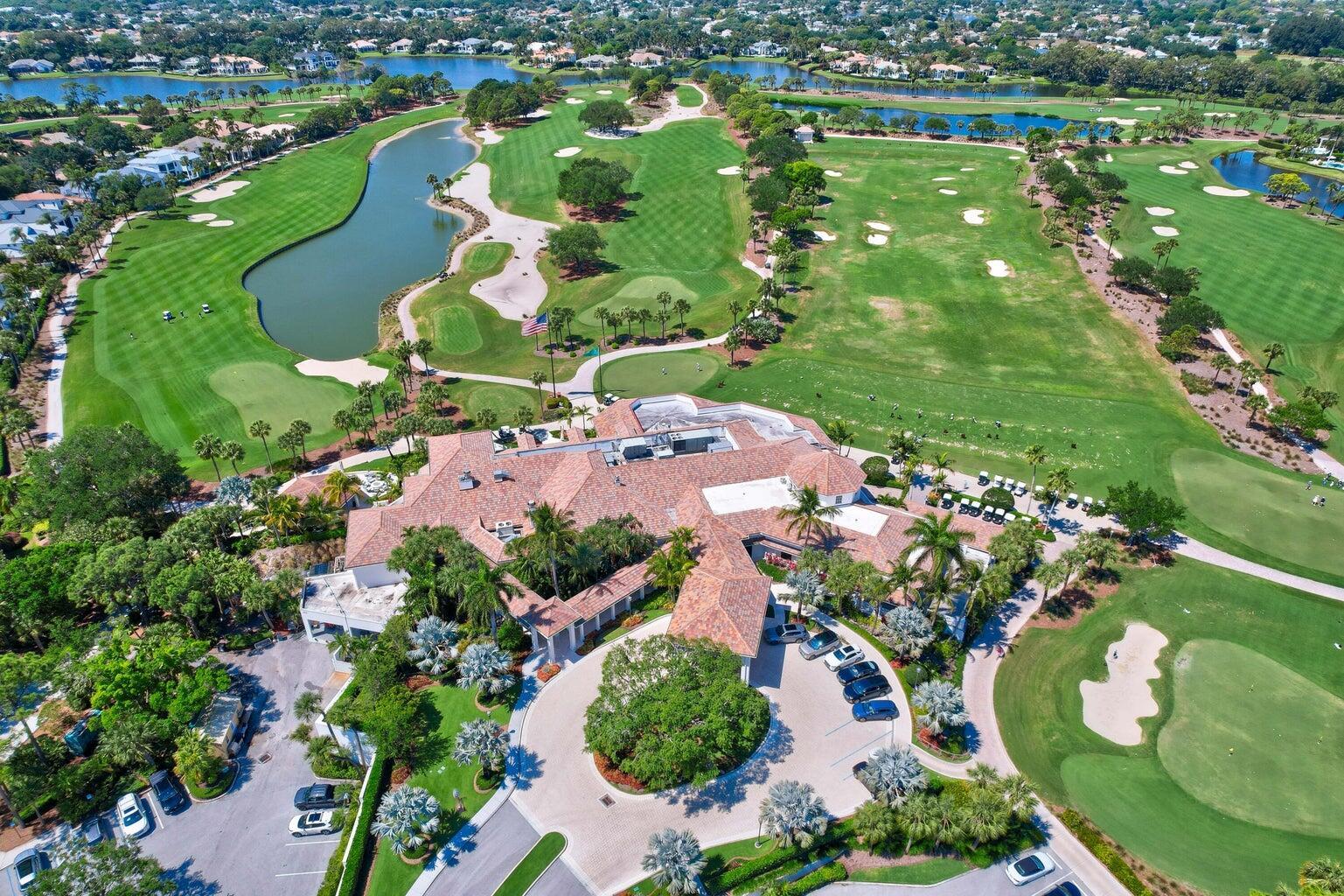 An aerial view of a clubhouse with a tiled roof surrounded by a golf course — 187 Birkdale Lane, Jupiter FL 33458, JUPITER, FL
