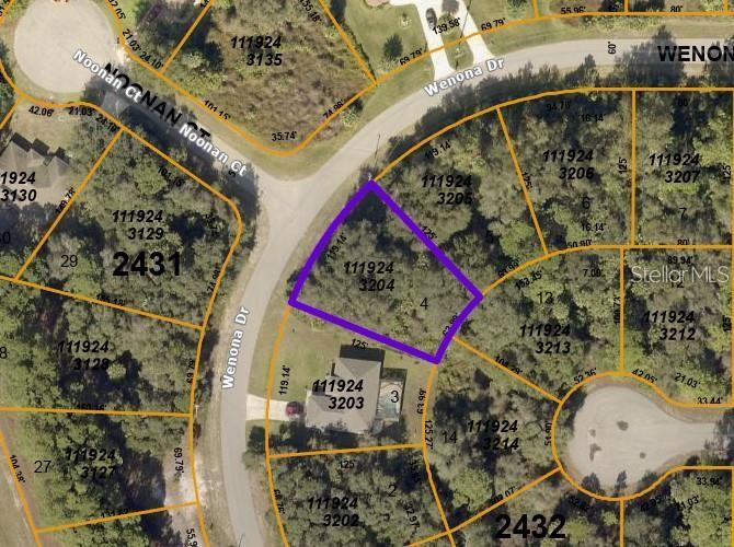 This is a satellite map showing a highlighted vacant residential lot in a suburban neighborhood — WENONA DRIVE, NORTH PORT, FL