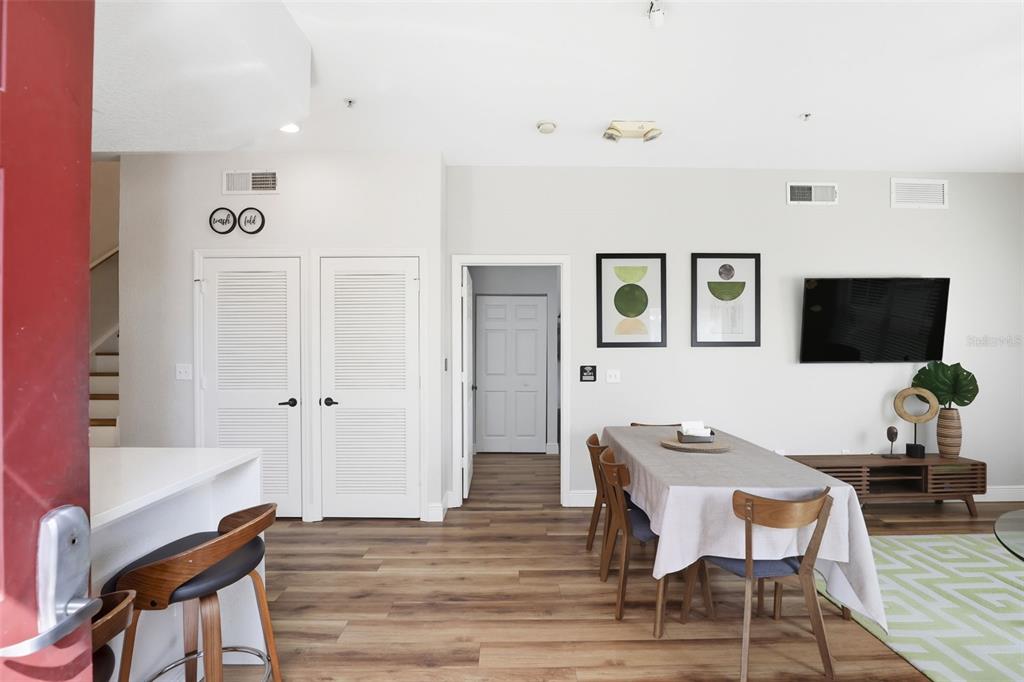 A dining area with a table and chairs sits near a kitchen counter and doorway — 2606 LODI CIRCLE UNIT 102, KISSIMMEE, FL