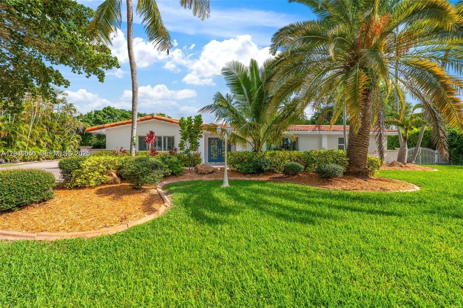 A single-story house with a red tile roof is surrounded by palm trees and landscaping — 6561 Marlin Dr, Coral Gables FL 33158, CORAL GABLES, FL