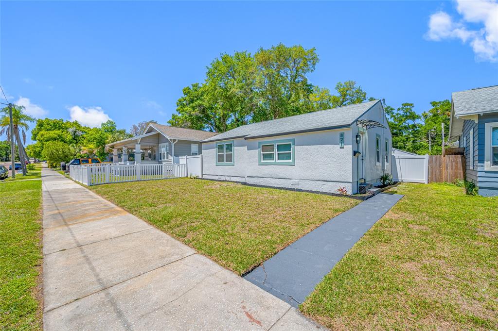 A light-colored, single-story house with a gray roof and a front walkway on a lawn — 821 19TH AVENUE S, ST PETERSBURG, FL
