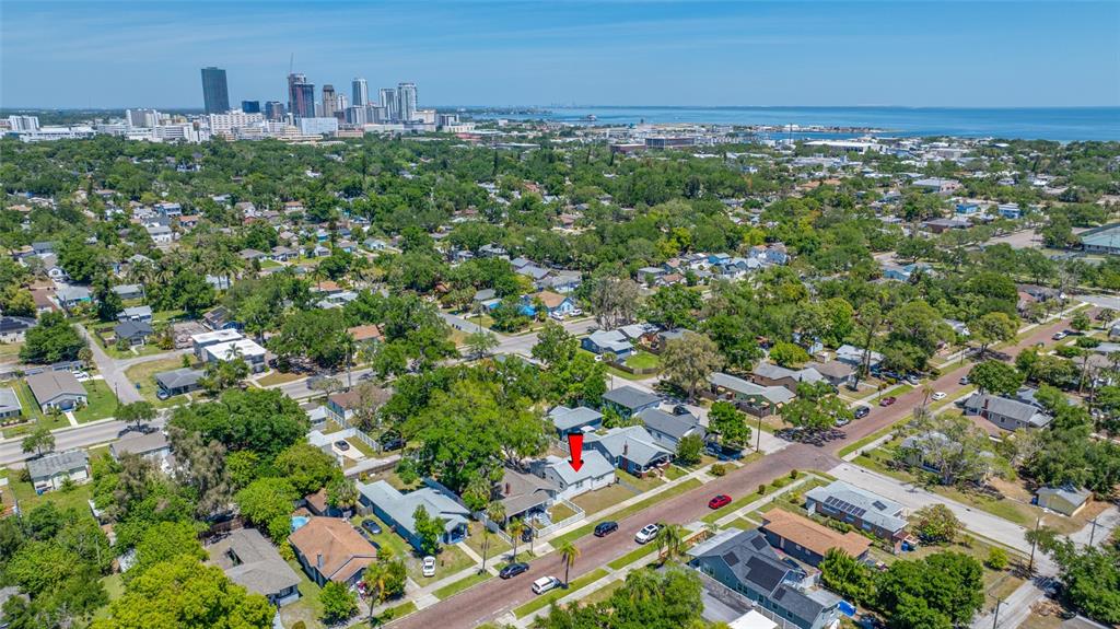 An aerial view shows a single-story house with a red arrow pointing to its roof — 821 19TH AVENUE S, ST PETERSBURG, FL