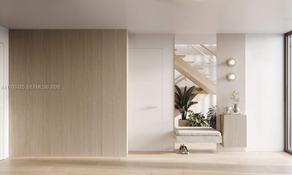 This rendering shows a minimalist entryway with wood paneling, a white door, and a bench — 1709 Jefferson Ave # 10, Miami Beach FL 33139, MIAMI BEACH, FL