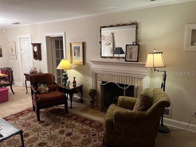 A living room features a fireplace with a mantel, a mirror, and two armchairs — 1628 NW 6TH AVENUE, GAINESVILLE, FL