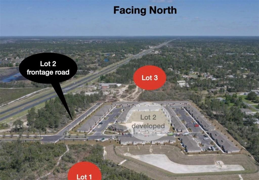 An aerial view shows three land lots, including one with a developed commercial building — COMMERCIAL WAY, BROOKSVILLE, FL