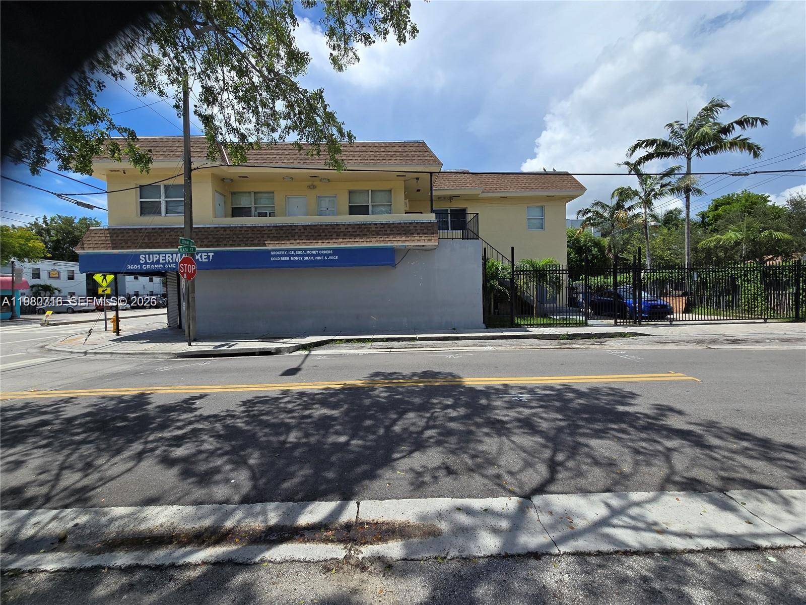 A two-story yellow building with a ground-floor storefront and upper-level residential units — 3380 Plaza St, Miami FL 33133, MIAMI, FL