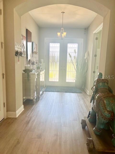A bright entryway features light wood-look flooring, a mirrored console table, and a decorative elephant statue — 2667 NORTHWOOD PARK STREET, VALRICO, FL