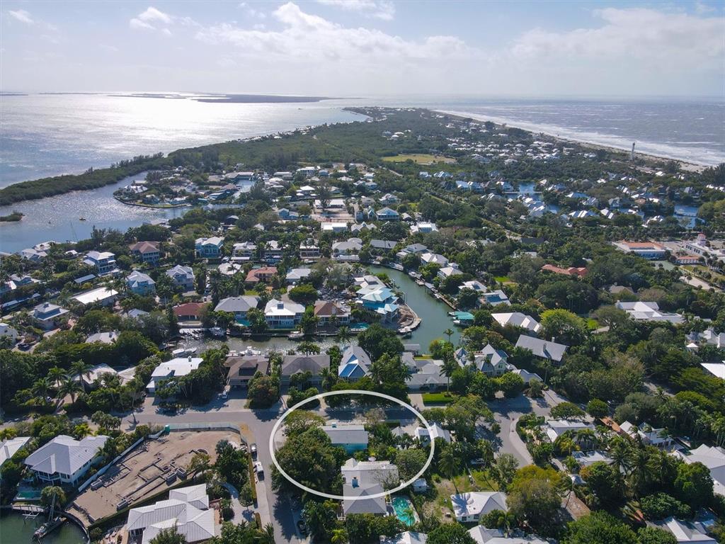 An aerial view of a coastal residential neighborhood with a house circled in white — 261 LEE AVENUE, BOCA GRANDE, FL