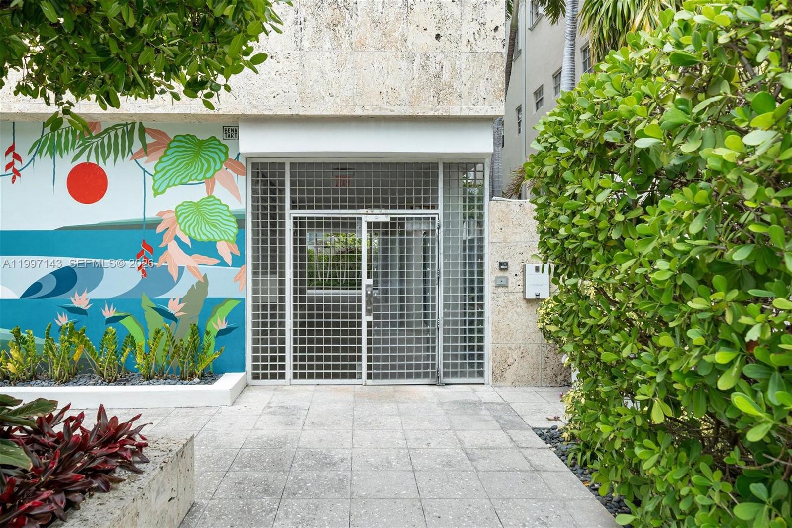 The exterior entrance features a metal security gate, a mural, and stone tile flooring — 226 Ocean Dr # 8F, Miami Beach FL 33139, MIAMI BEACH, FL
