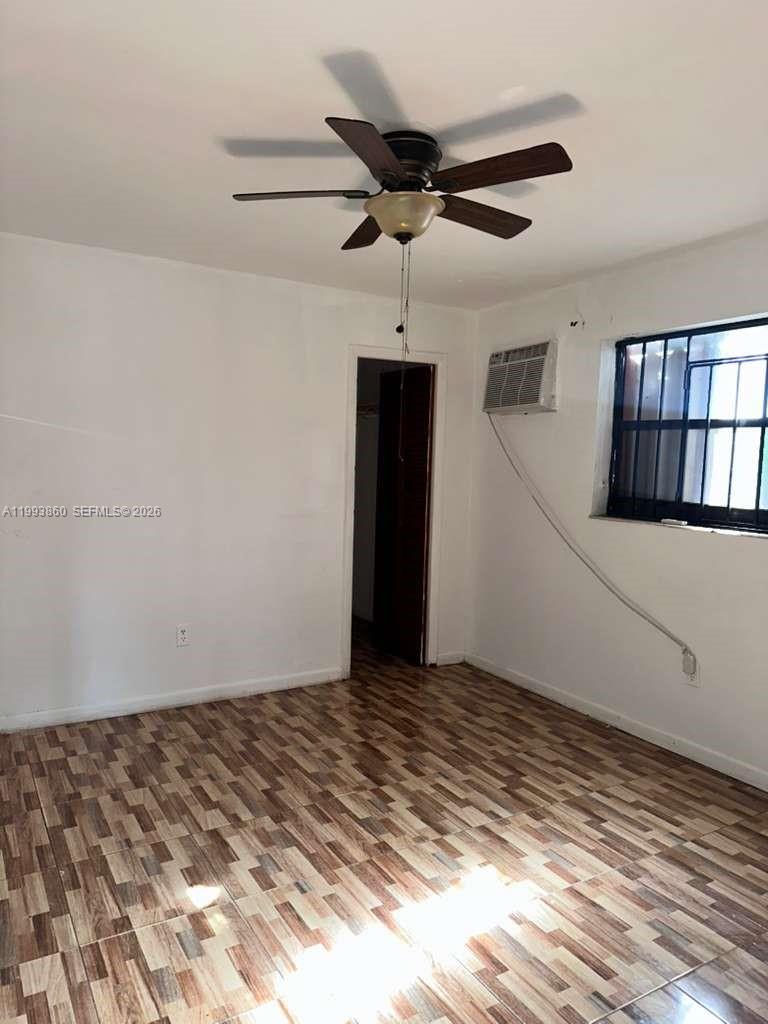 This room features tiled flooring, a ceiling fan, a window air conditioner, and a closet — 576 NW 147th St # 576, Miami FL 33168, MIAMI, FL