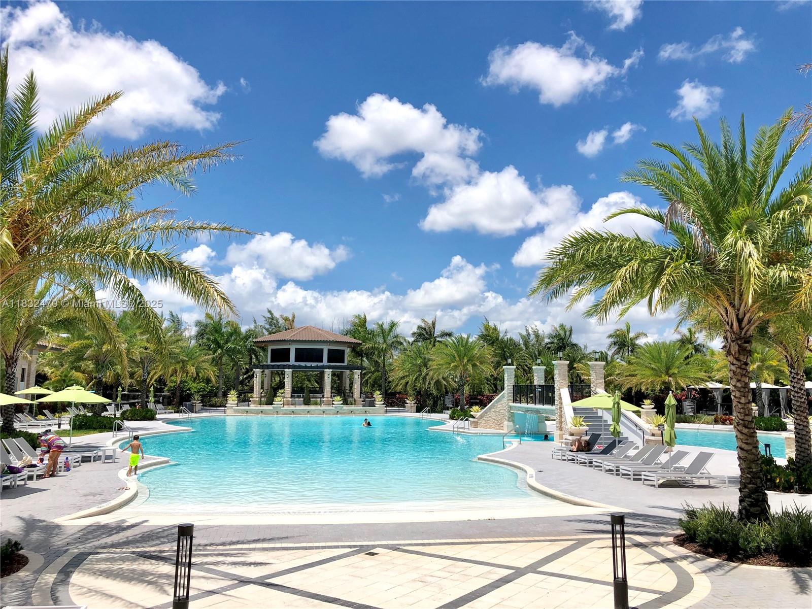 A large outdoor swimming pool features a gazebo, palm trees, and lounge chairs on a patio — 8031 NW 104th Ave # 21, Doral FL 33178, DORAL, FL