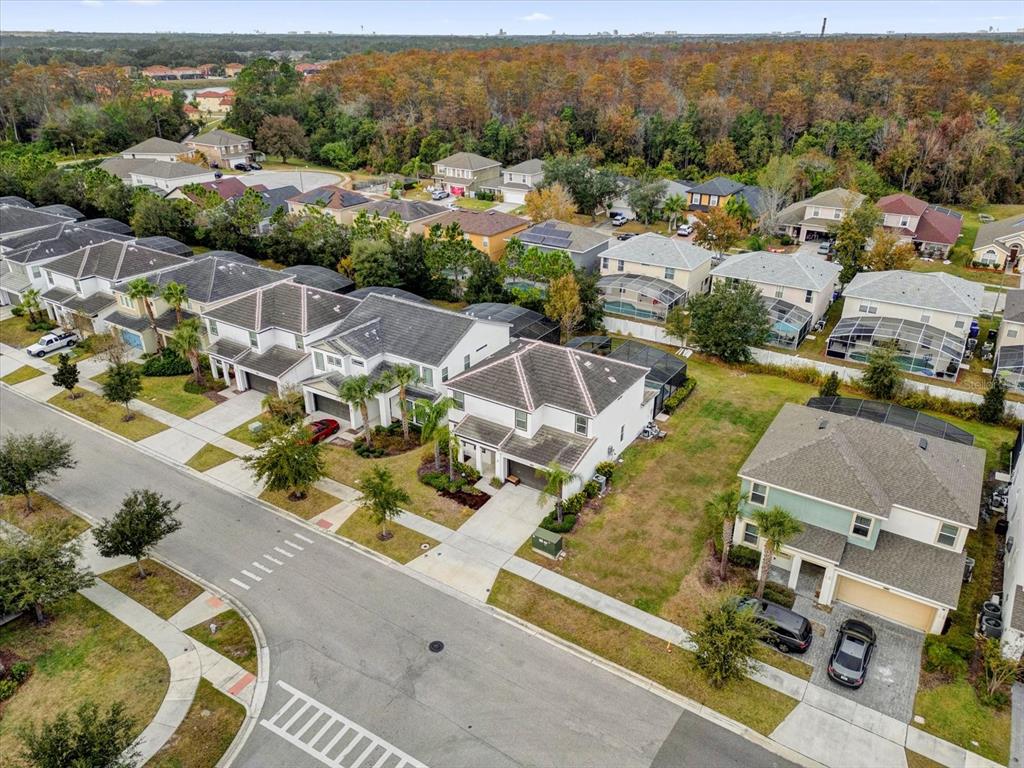 An aerial view shows a suburban neighborhood with multiple two-story houses and paved streets — 4501 MONADO DRIVE, KISSIMMEE, FL