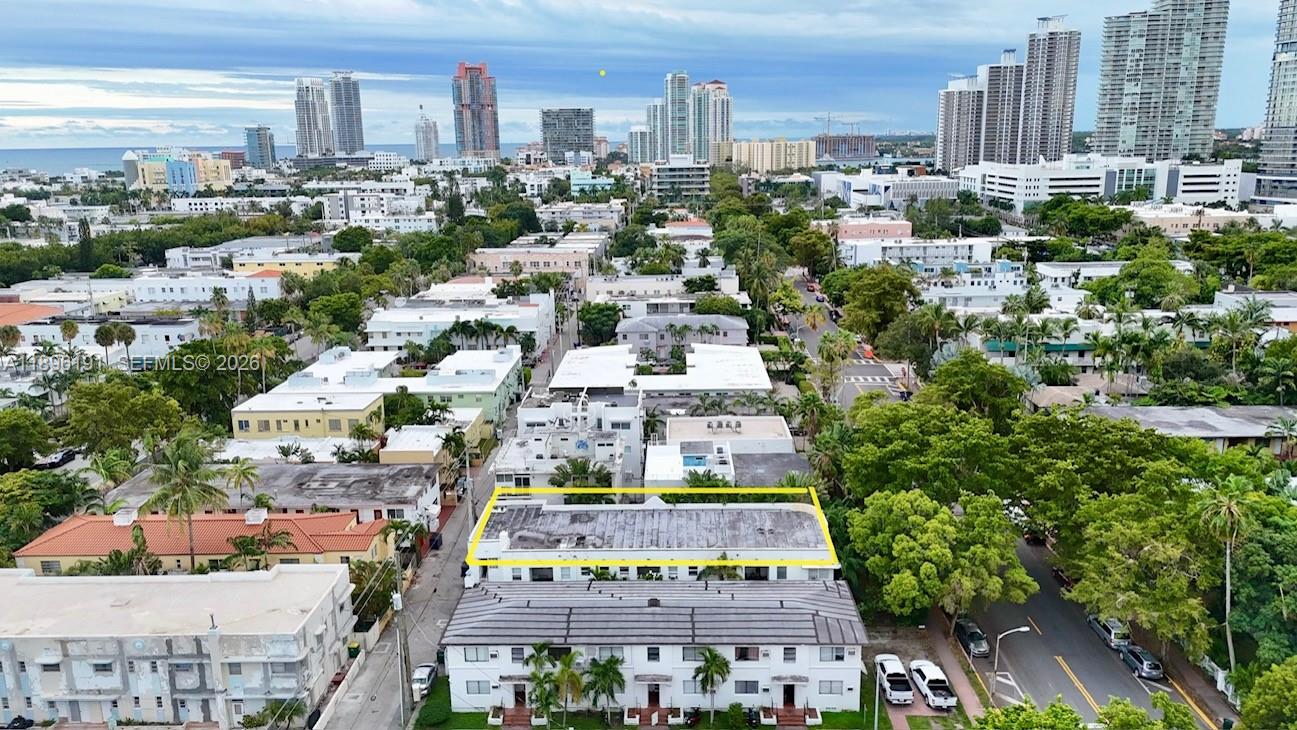 An exterior view of a multi-story apartment building with parked cars on the street — 845 Michigan Ave, Miami Beach FL 33139, MIAMI BEACH, FL