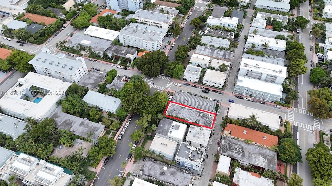 A narrow concrete walkway leads between a white building and lush tropical landscaping — 845 Michigan Ave, Miami Beach FL 33139, MIAMI BEACH, FL