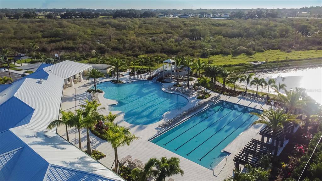 An aerial view shows a community pool area with a lap pool and a slide — 4027 WESTWOOD FIELDS LOOP, PLANT CITY, FL