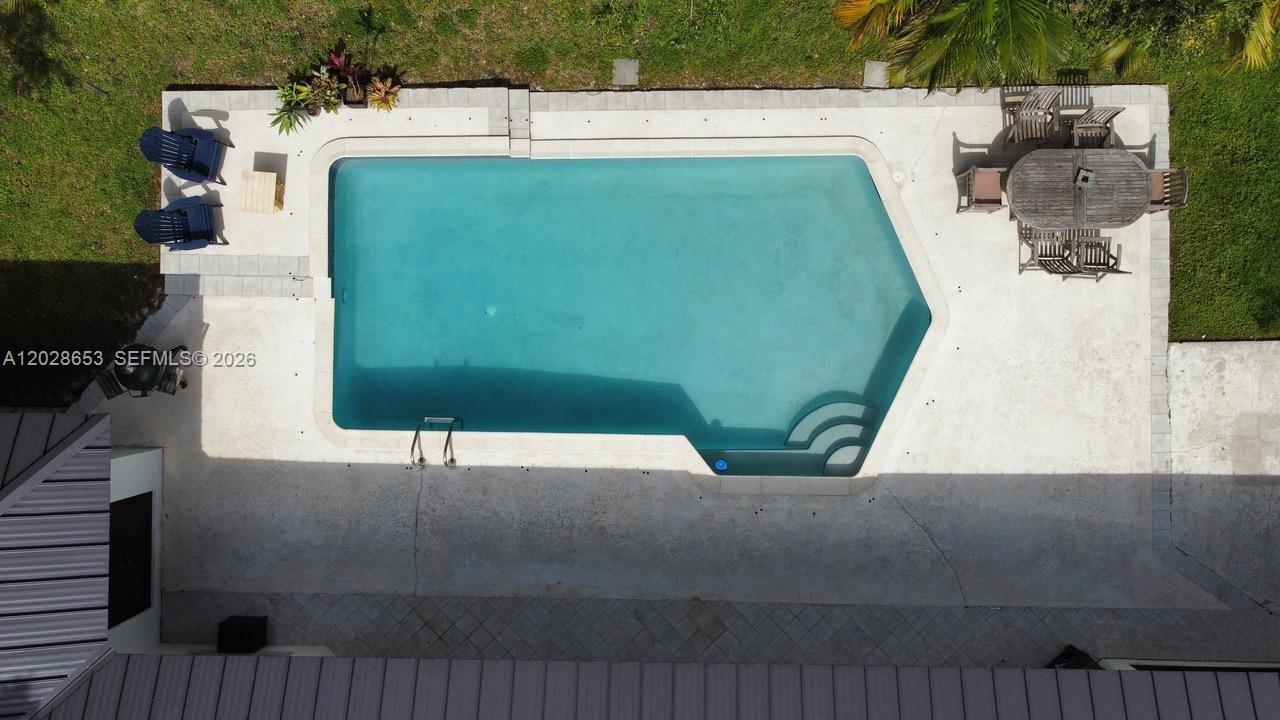 An aerial view shows a swimming pool with a patio, outdoor furniture, and landscaping — 13324 SW 106th Ave, Miami FL 33176, MIAMI, FL