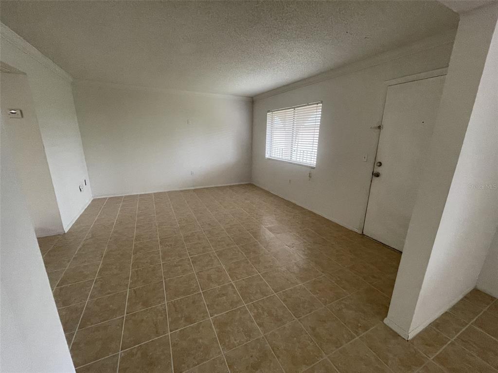 An empty room features beige tile flooring, white walls, and a single window with blinds — 139 OYSTER BAY CIRCLE UNIT 340, ALTAMONTE SPRINGS, FL