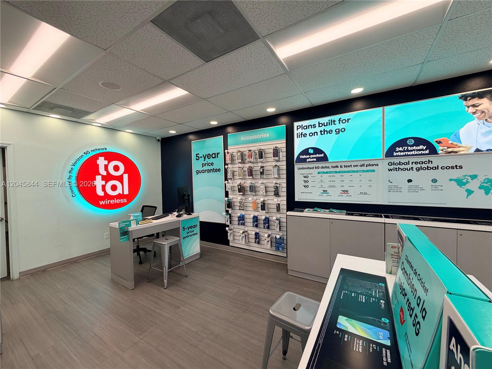 A retail store interior features a Total Wireless service counter, accessory display wall, and promotional signage — confidential, Hialeah Gardens 00000, HIALEAH GARDENS, FL