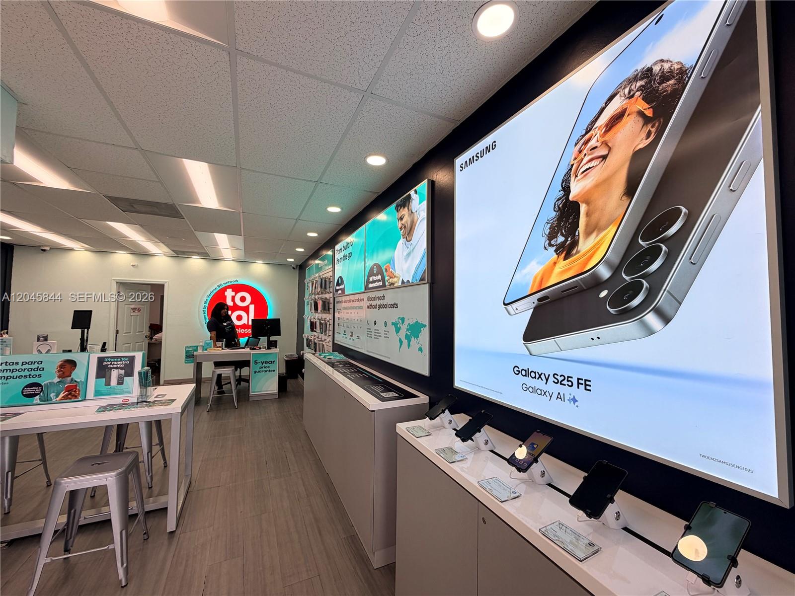 A retail mobile phone store features display counters, wall-mounted advertisements, and a service desk — confidential, Hialeah Gardens 00000, HIALEAH GARDENS, FL