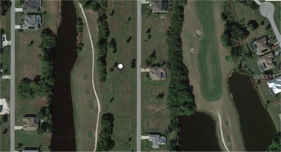 This aerial map shows a vacant residential lot situated between a road and a golf course — 30 PINE VALLEY PLACE, ROTONDA WEST, FL
