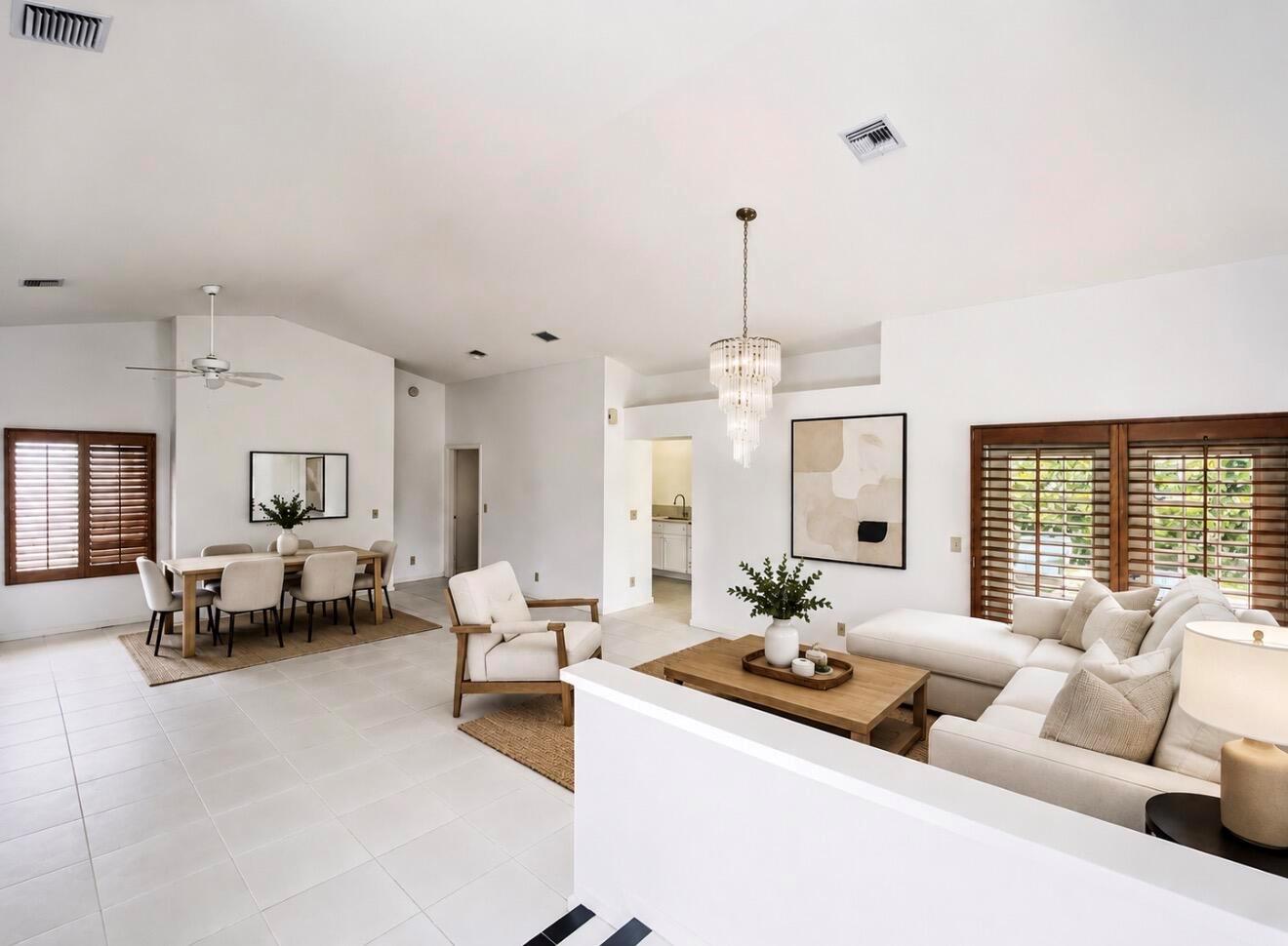 A bright, open-concept living and dining area features white tile floors and wood-framed shutters — 10533 Mendocino Lane, Boca Raton FL 33428, BOCA RATON, FL