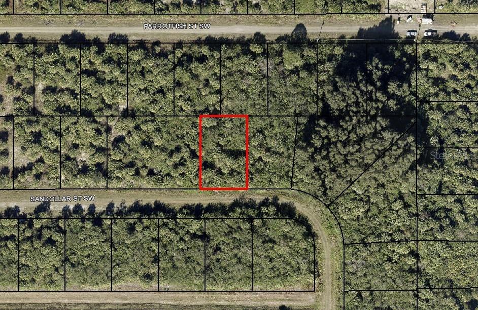 This is an aerial map showing a vacant, rectangular lot outlined in red — 843 SANDOLLAR STREET SW, PALM BAY, FL