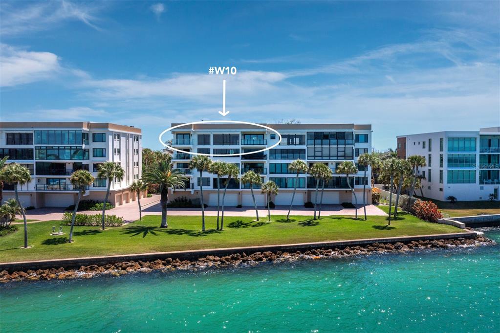 An aerial view shows a multi-story waterfront apartment building with a designated unit circled — 4712 OCEAN BOULEVARD UNIT W10, SARASOTA, FL