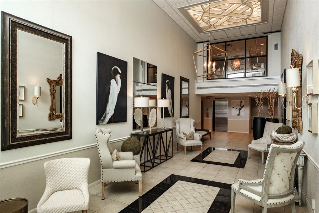A bright, elegant lobby features tiled floors, upholstered armchairs, large mirrors, and a decorative ceiling — 8 BELLEVIEW BOULEVARD UNIT 108, BELLEAIR, FL