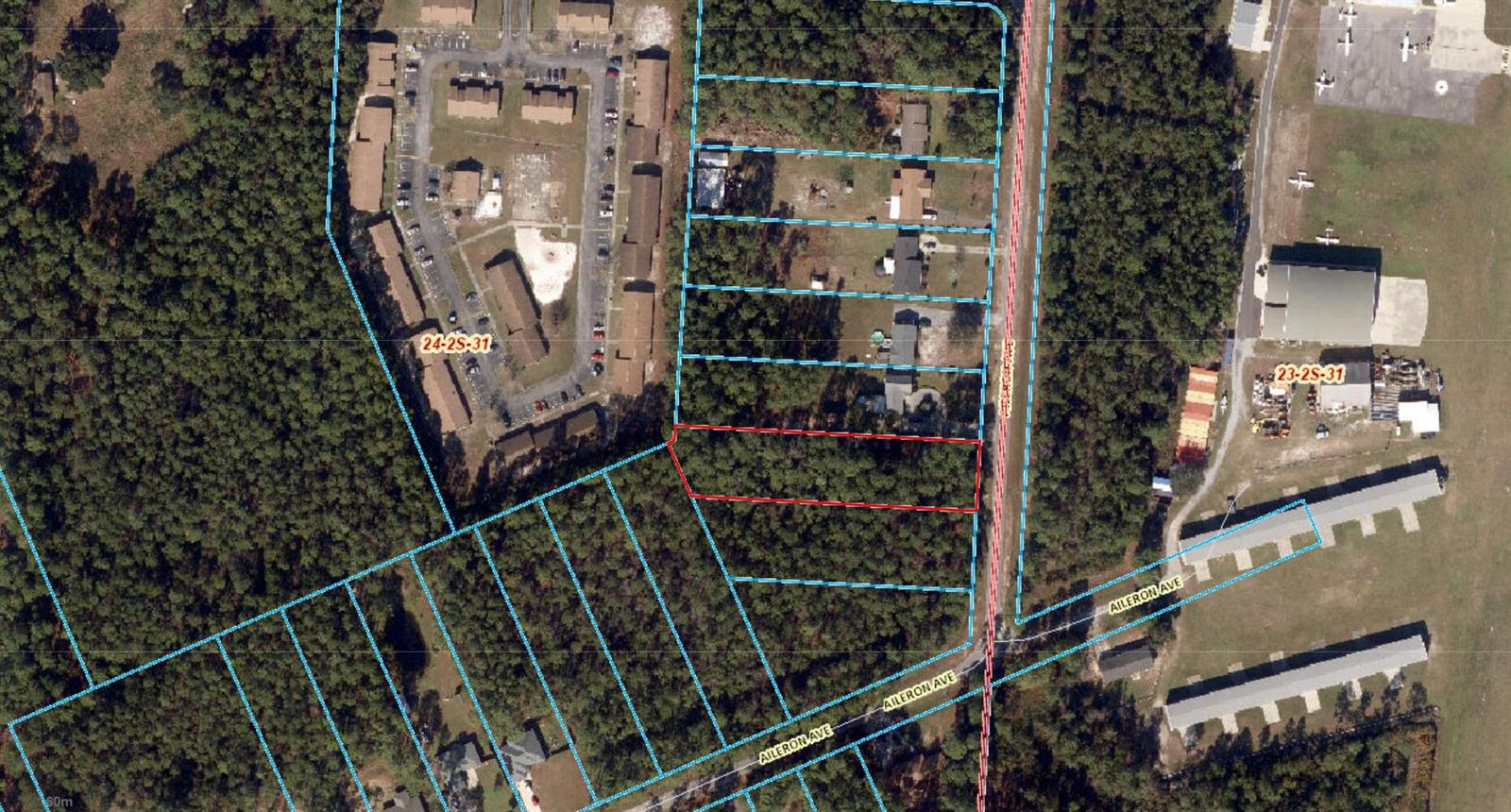 This is an aerial map showing a highlighted rectangular land parcel among wooded lots — 9897 Aileron Avenue, FL 32506, FL