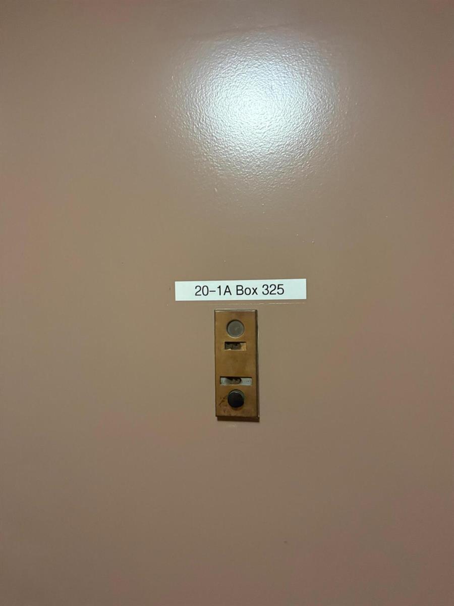 A doorbell button is mounted on a beige wall below a label reading 20-1A Box 325 — 4394 NW 9th Avenue # 1a, Pompano Beach FL 33064, POMPANO BEACH, FL