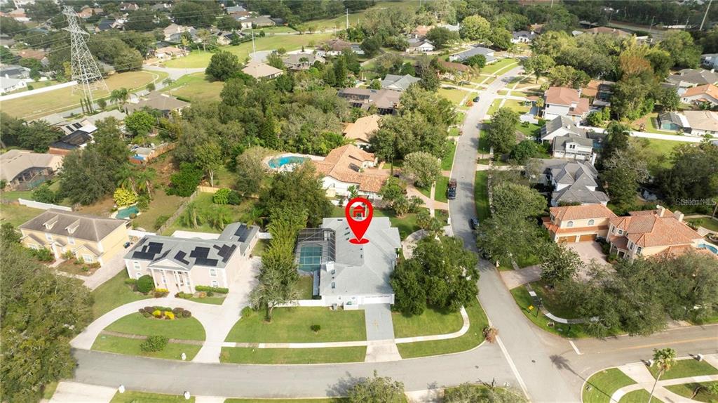 An aerial view shows a single-story house with a pool and a red location pin — 5646 MASTERS BOULEVARD, ORLANDO, FL