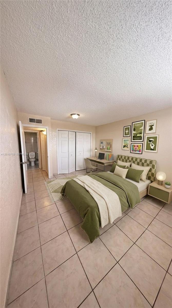 A bedroom features a bed with green bedding, a desk, and an attached bathroom — 666 W 81st St # 316, Hialeah FL 33014, HIALEAH, FL