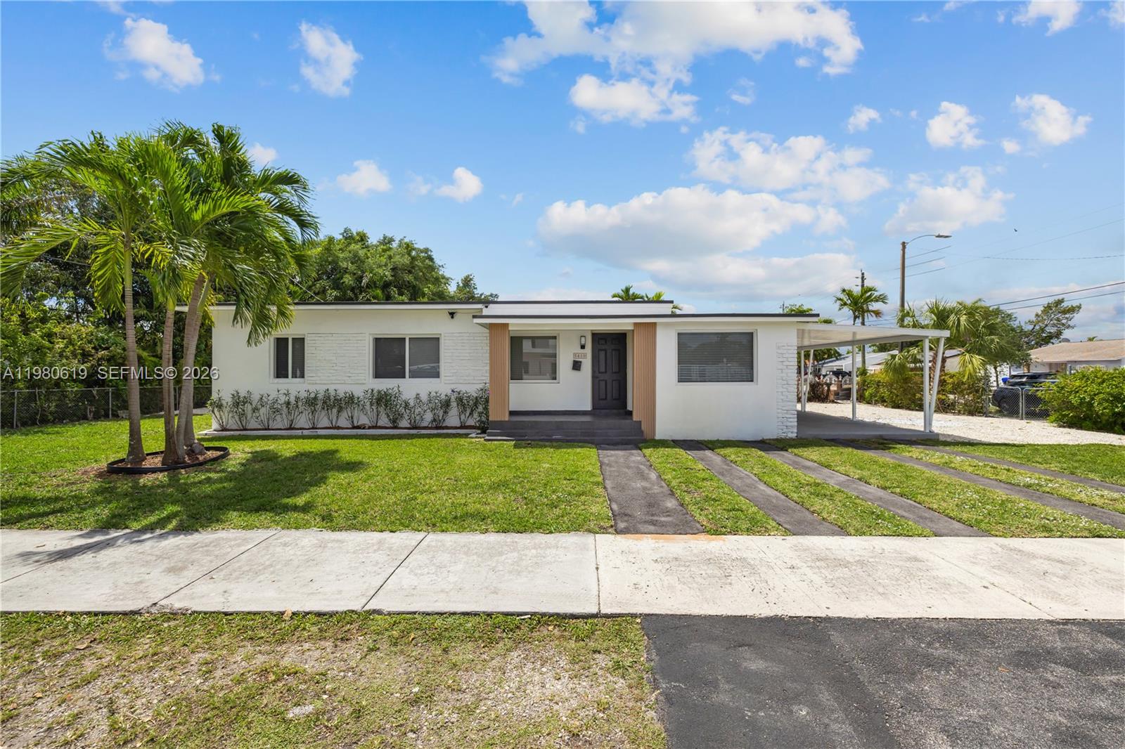 A single-story white house features a front lawn, a carport, and a paved driveway — 5410 SW 2nd, Miami FL 33134, MIAMI, FL