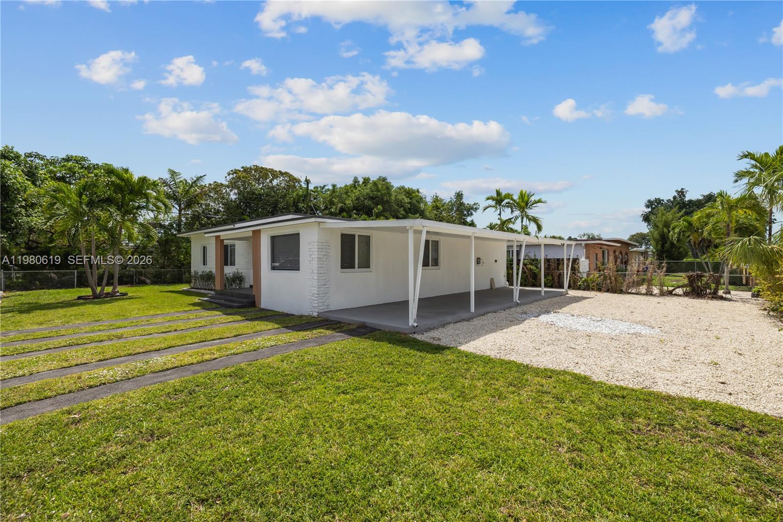 A white single-story house features a large covered carport and a gravel driveway — 5410 SW 2nd, Miami FL 33134, MIAMI, FL