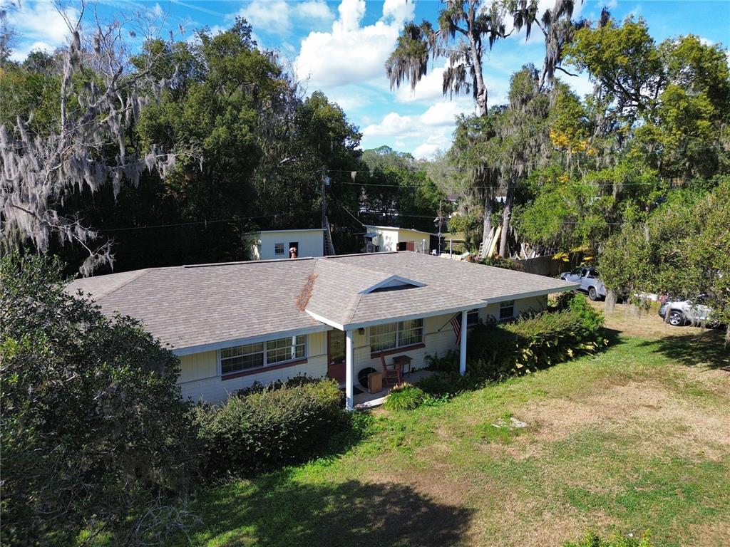An aerial view of a single-story house with a shingled roof and a front porch — 1324 SE 33RD TERRACE, OCALA, FL