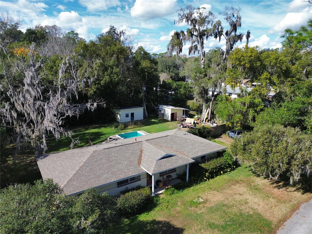 An aerial view shows a single-story house with a pool and two detached sheds — 1324 SE 33RD TERRACE, OCALA, FL