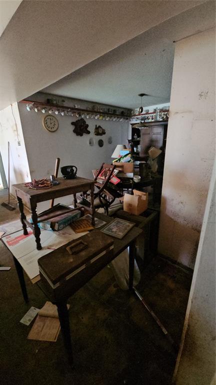 A cluttered room features a wooden table, a small desk, and wall-mounted shelves with mugs — 2116 WINNETKA COURT, ORLANDO, FL