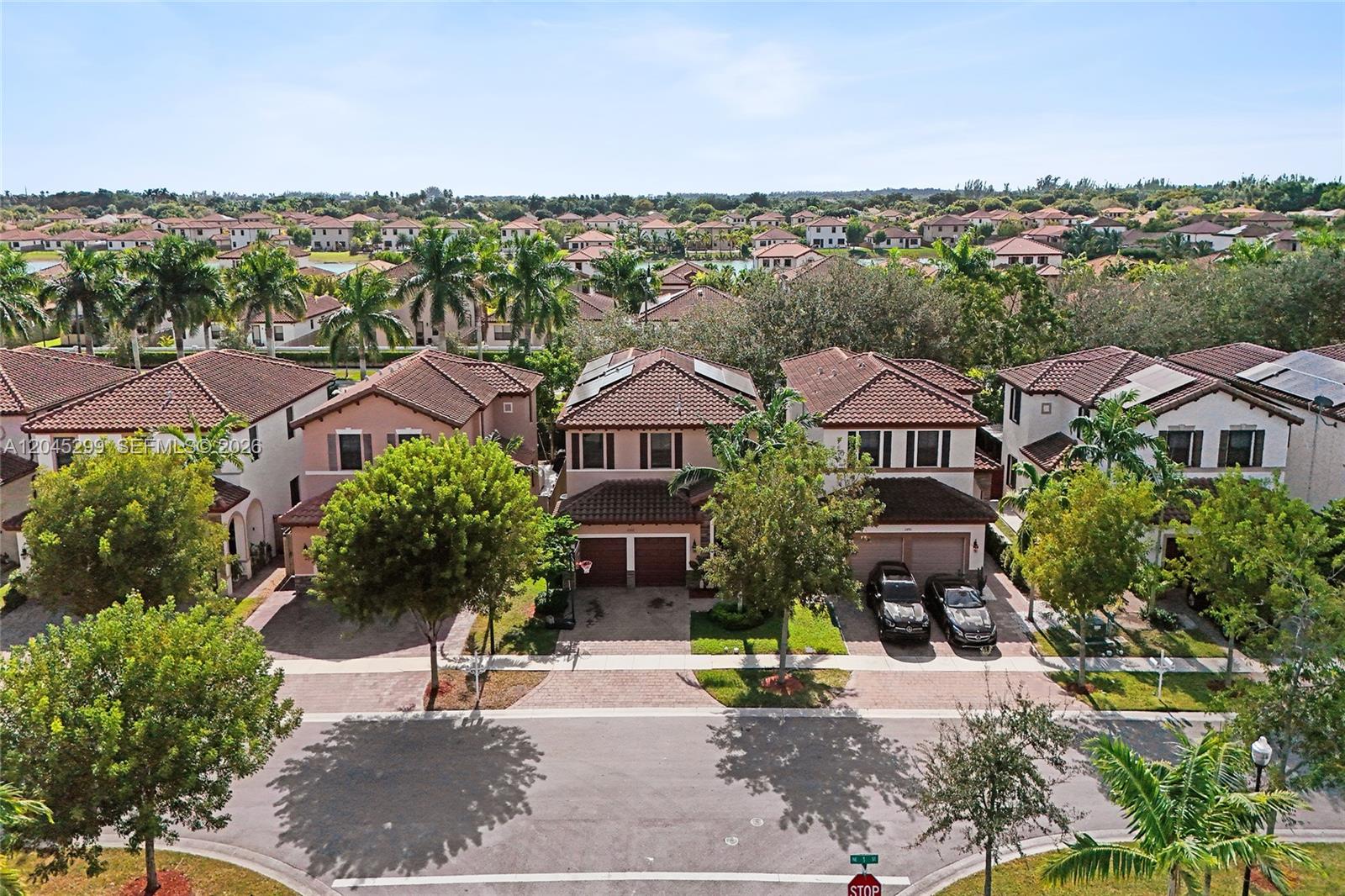 An aerial view shows a row of two-story suburban houses with tile roofs and driveways — 2502 NE 1st St # 0, Homestead FL 33033, HOMESTEAD, FL