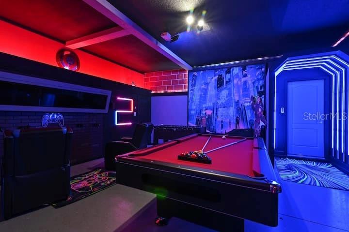 A game room features a pool table, neon lighting, and a wall mural — 1455 BELLE TERRE ROAD, DAVENPORT, FL