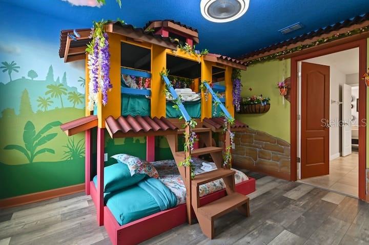 A bedroom features a custom, multi-level bunk bed designed to look like a house — 1455 BELLE TERRE ROAD, DAVENPORT, FL