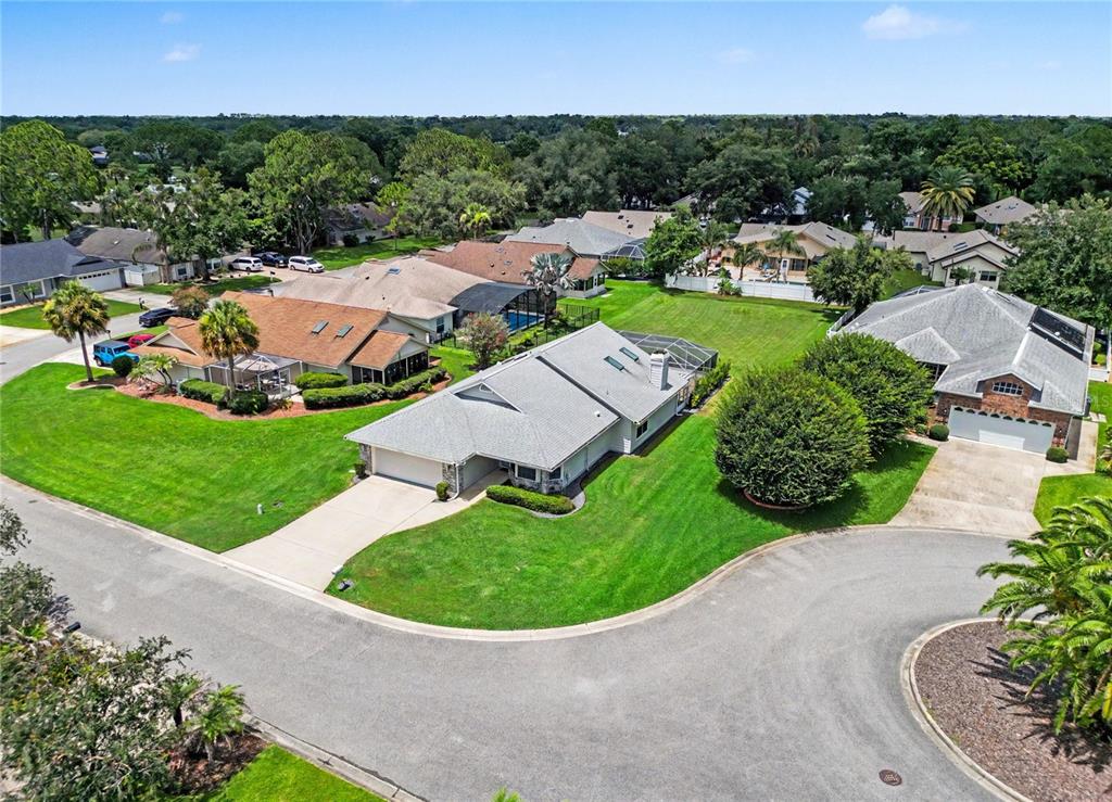 An aerial view shows a suburban neighborhood with several single-family homes and manicured lawns — 2013 BEAVER CREEK DRIVE, PORT ORANGE, FL