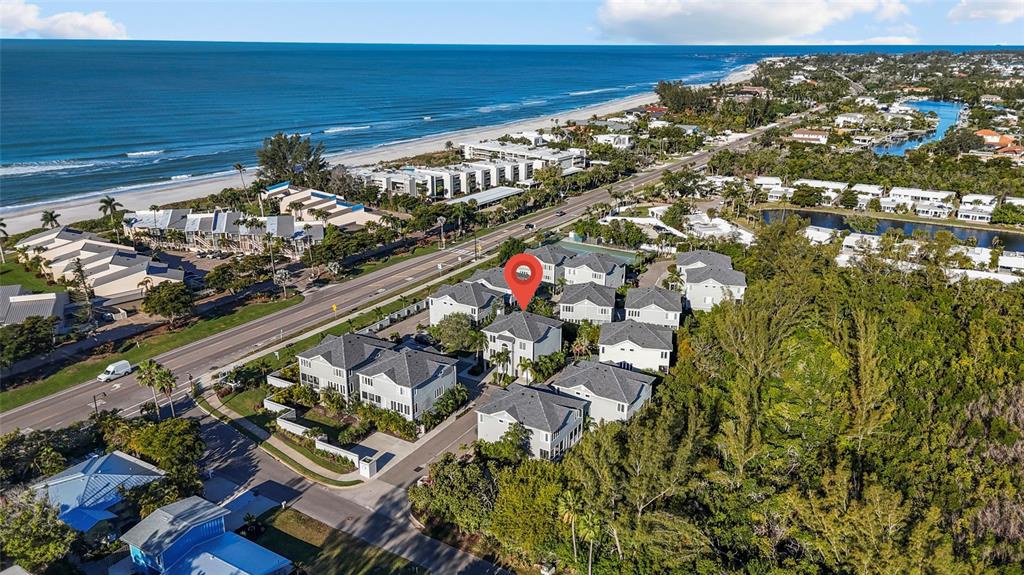 An aerial view shows a residential neighborhood with a red location pin over a house — 515 FOREST WAY, LONGBOAT KEY, FL