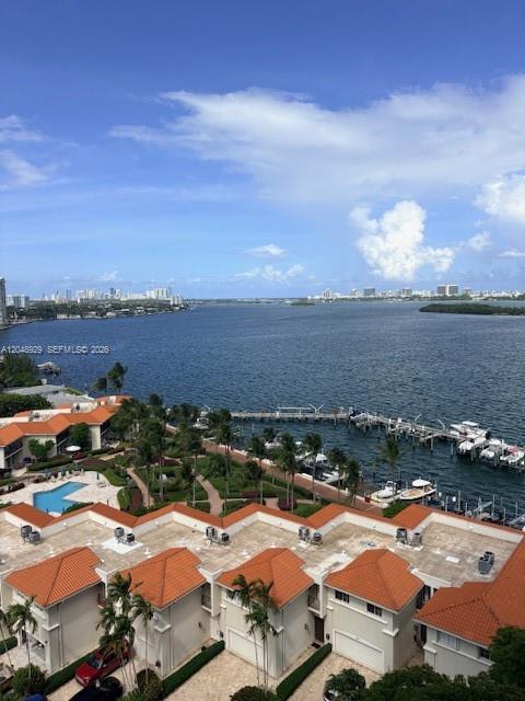 An elevated view shows a waterfront residential complex with orange-tiled roofs and a boat dock — 4000 Towerside Ter # 1403, Miami FL 33138, MIAMI, FL