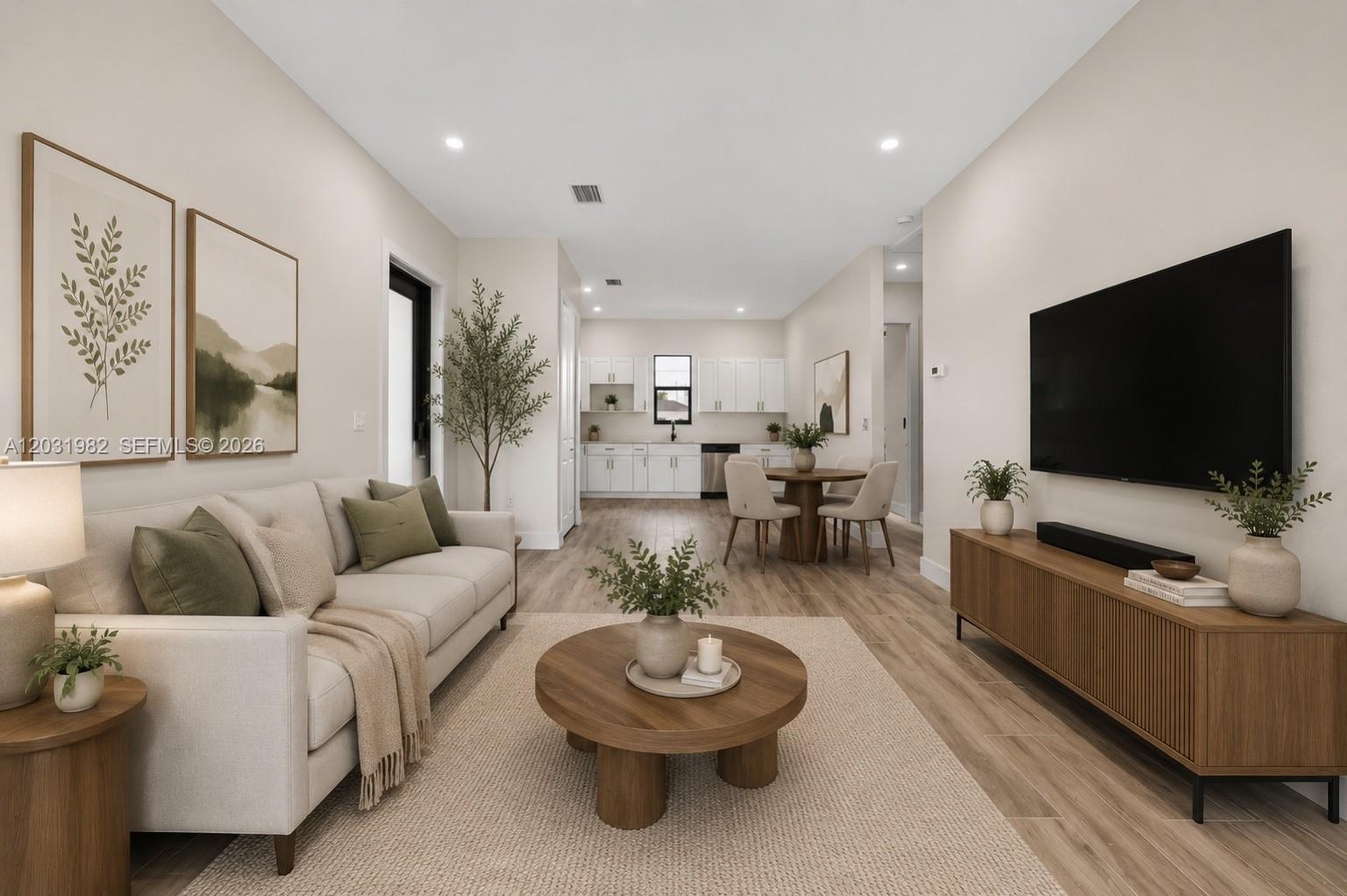 This rendering shows an open-concept living and dining area with light wood-look flooring — 2622 22 Avenue SE, Naples FL 34117, NAPLES, FL