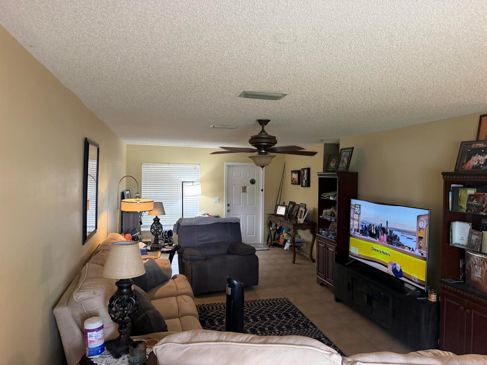 A kitchen features wood cabinets, a laminate countertop breakfast bar, and two pendant lights — 6718 Duval Avenue, West Palm Beach FL 33411, WEST PALM BEACH, FL